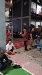 Nighttime hangout scene in South Tangerang with motorcycles and badminton