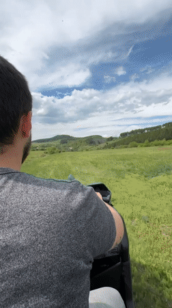 Motorcyclist rides through field near Breznik, Bulgaria