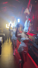 Masked performers and glowing letters at a North Kuta nightclub event