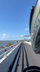 Motorcycle ride captured on Bali Mandara Toll Road bridge
