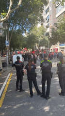 Demonstrators with red flags march through Barcelona streets