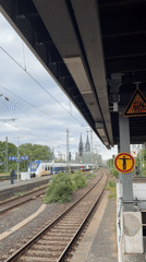 Morning train platform view captures Cologne Cathedral backdrop