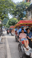 Cyclos and festive street decor in central Hanoi