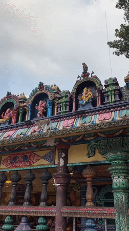 Batu Caves: golden statue, colorful stairs, and roaming macaques