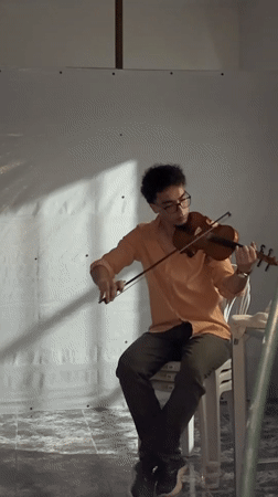 Violin playing in a sparse Gaza room, July 2026