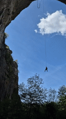Person rappels from stone arch in Karlukovo, Bulgaria