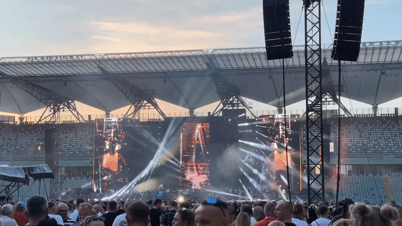 Packed outdoor concert at PGE Narodowy under a summer sunset