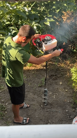 Post holes being drilled in a Plovdiv backyard one morning