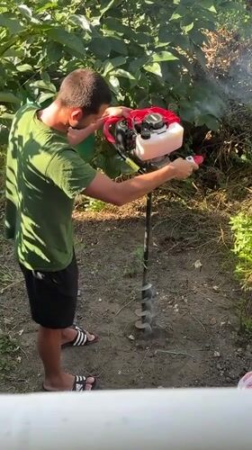 Post holes being drilled in a Plovdiv backyard one morning