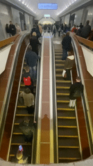 Busy Moscow subway escalators carry commuters during afternoon rush