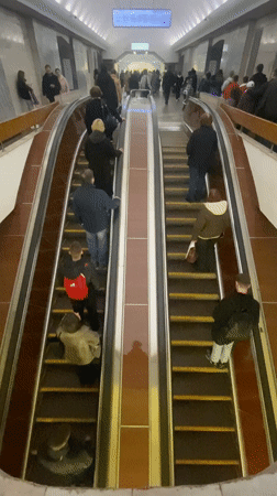 Busy Moscow subway escalators carry commuters during afternoon rush