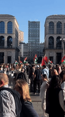 Pro-Palestinian demonstration gathers near red sculpture in city square