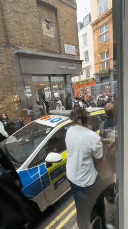 Teenagers queue at London vintage store under police supervision