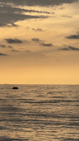 Jet ski on glassy water at golden hour, Riviera Beach