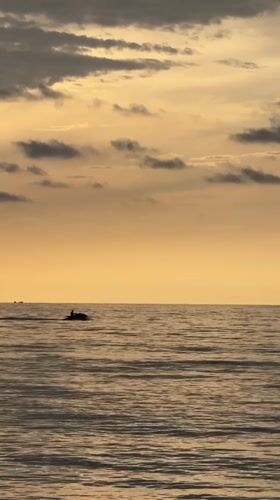 Jet ski on glassy water at golden hour, Riviera Beach