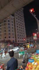 Motorcycle rider captures nighttime traffic scene in Dhaka