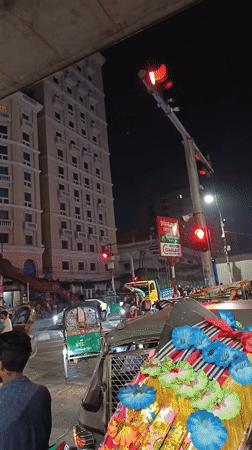 Motorcycle rider captures nighttime traffic scene in Dhaka