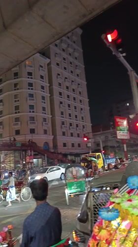 Motorcycle rider captures nighttime traffic scene in Dhaka