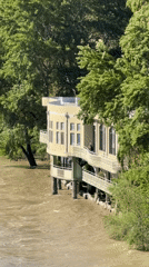 Flood waters flow past elevated building in Tbilisi