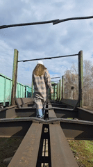 Woman walks on empty railway flatcar in Chaikovsky