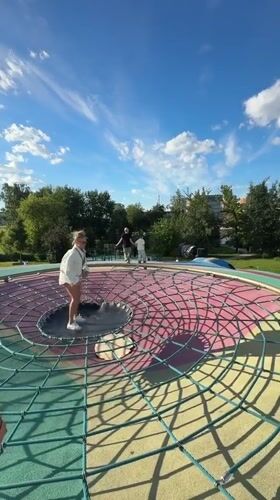 Moscow park afternoon: sculptures, trampolines, and outdoor workouts