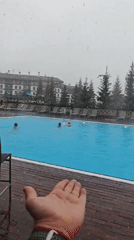 Late spring snowfall hits Russian resort with outdoor pool