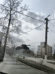 Vehicle passes tank monument in Chaikovsky public square