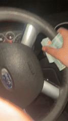Person handles cash inside Ford vehicle at night