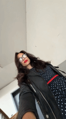 Woman takes selfies indoors in Pleven, Bulgaria