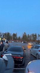 Spectators gather to watch car drifting in Russian parking lot