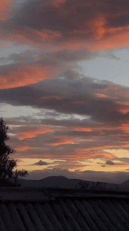 Dramatic sunset illuminates Ushuaia skyline with golden hues