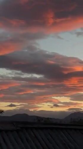 Dramatic sunset illuminates Ushuaia skyline with golden hues