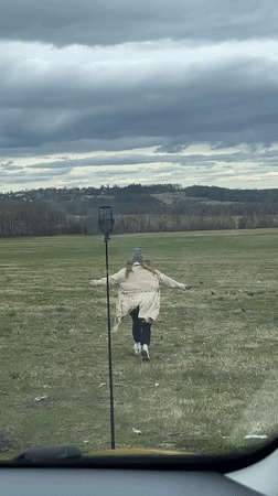 Woman films personal video in Russian field near Popelkovo