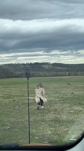 Woman films personal video in Russian field near Popelkovo