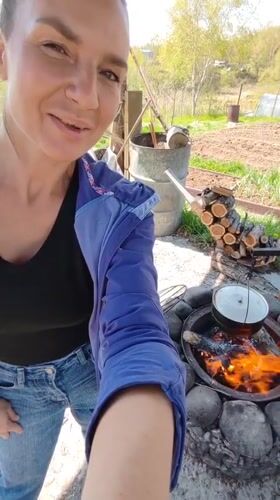 Woman documents early morning outdoor cooking, gardening in rural Russia