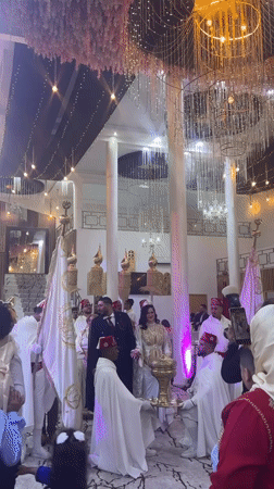 Wedding procession held in ornate hall in Marrakesh
