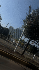 Vehicle travels past buildings and infrastructure in Tlaxcalancingo