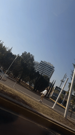 Vehicle travels past buildings and infrastructure in Tlaxcalancingo