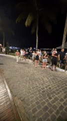 Nighttime street performances draw crowds in Brazilian coastal resort town