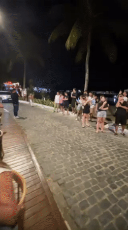 Nighttime street performances draw crowds in Brazilian coastal resort town