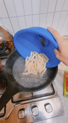 Cook prepares rice cake dish in South Korean kitchen