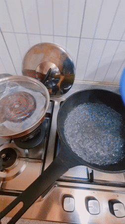 Cook prepares rice cake dish in South Korean kitchen
