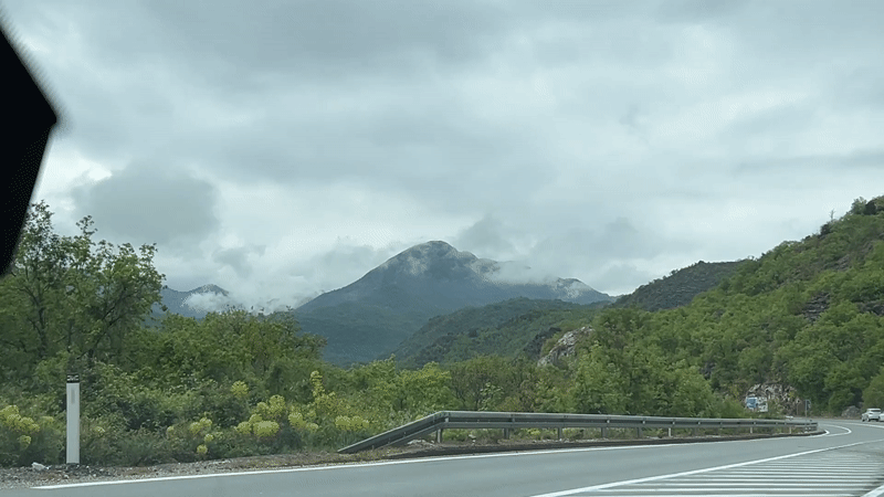 Vehicle travels mountain road in Gornja Brova, Montenegro