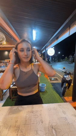 Woman enjoys evening meal at Thai street restaurant in Patong