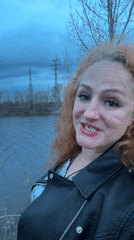 Woman takes selfies by water in Chaikovsky, Russia