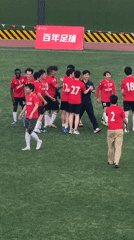 Soccer team in red celebrates victory at Shanghai field
