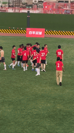 Soccer team in red celebrates victory at Shanghai field