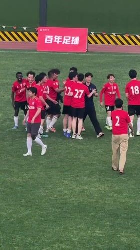 Soccer team in red celebrates victory at Shanghai field