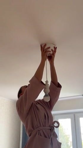 Replacing light fixtures in a Moscow apartment, pink robe required