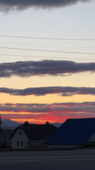 Sunset displays colorful sky over residential neighborhood